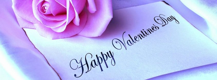 Happy Valentine's Day written on a note with a pink rose